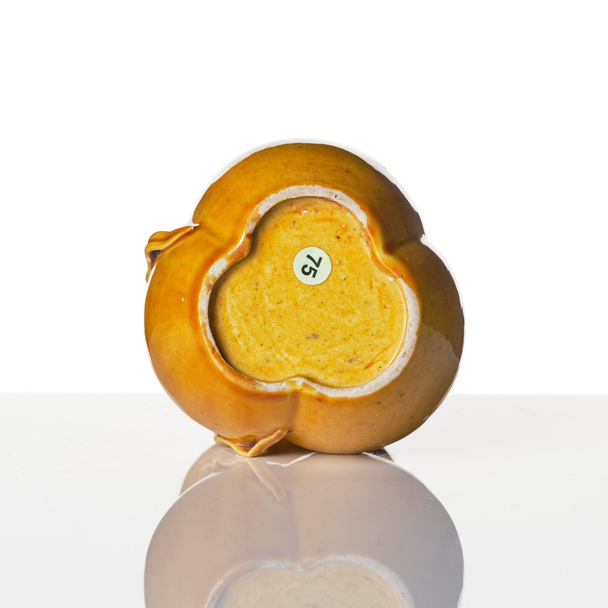 A yellow glazed triple spouted double gourd vase, Qing dynasty, 18th century.