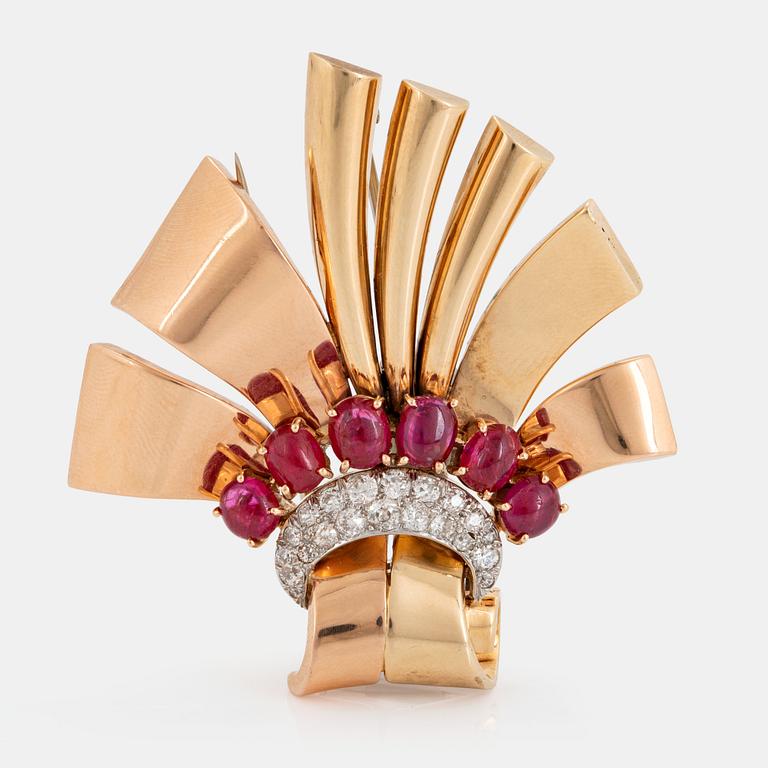 A 14K gold brooch set with cabochon-cut rubies and old-cut diamonds.