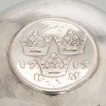 A silver tumbler with inset Swedish coin dated 1713.