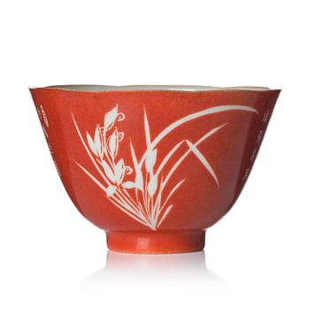 1319. A coral-ground reserve decorated 'orchids' cup, late Qing dynasty.