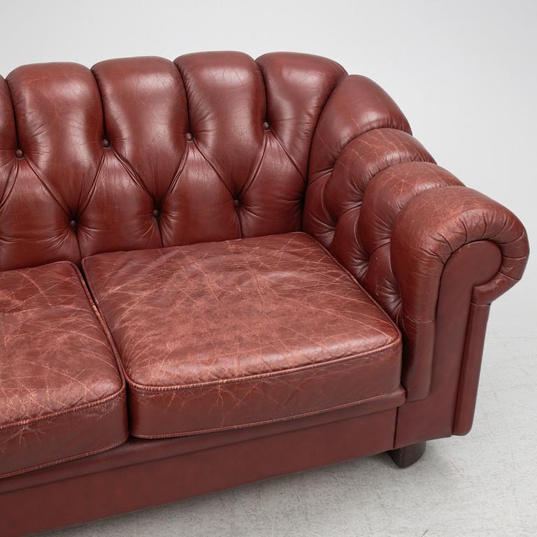 A sofa and a pair of armchairs, 'Chesterfield model', late 20th Century.