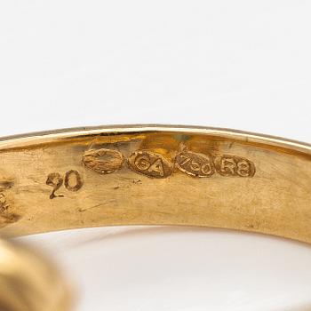 An 18K gold ring with diamonds ca. 0.02 ct and an emerald. Finnish import marks.
