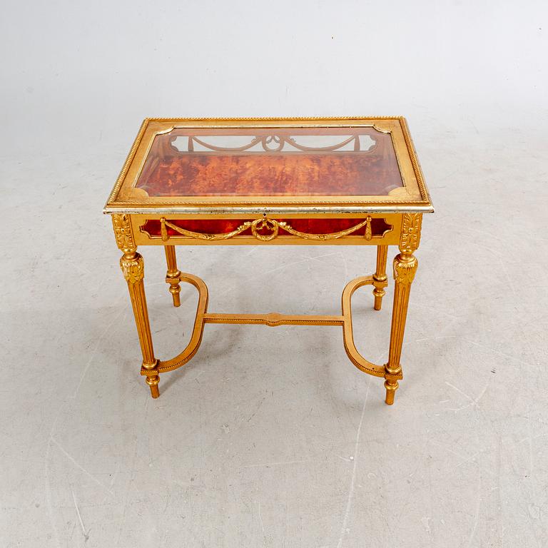 A gilded Louis XVI style display table first half of the 20th century.