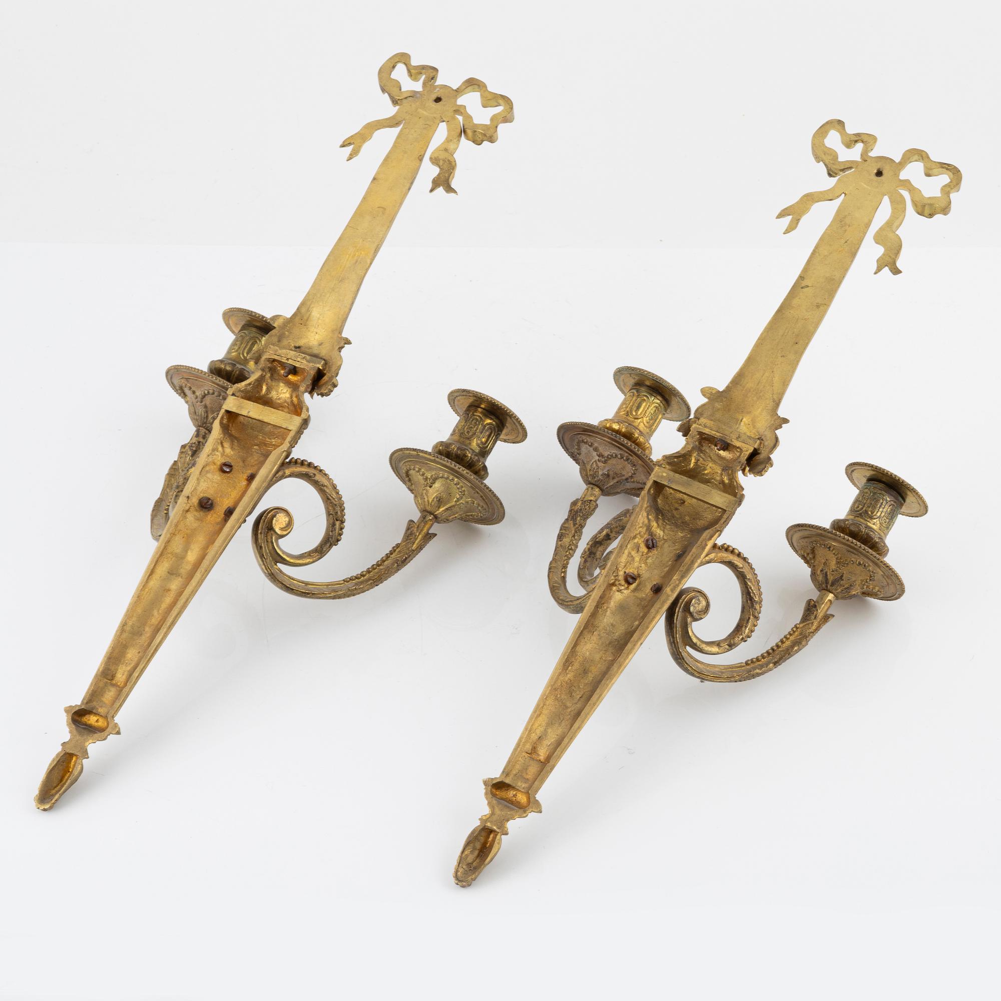 A pair of gilt brass wall sconces, Louis XVI-style, early 20th century.