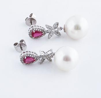 A pair of cultured pearl, ca 1.08 cts ruby and 0.34 cts brilliant cut diamond earrings.