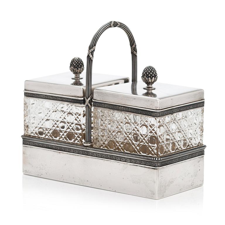 K. Fabergé, a pair of cut-glass toilette boxes in silver stand, Imperial Warrant mark, Moscow 1896.