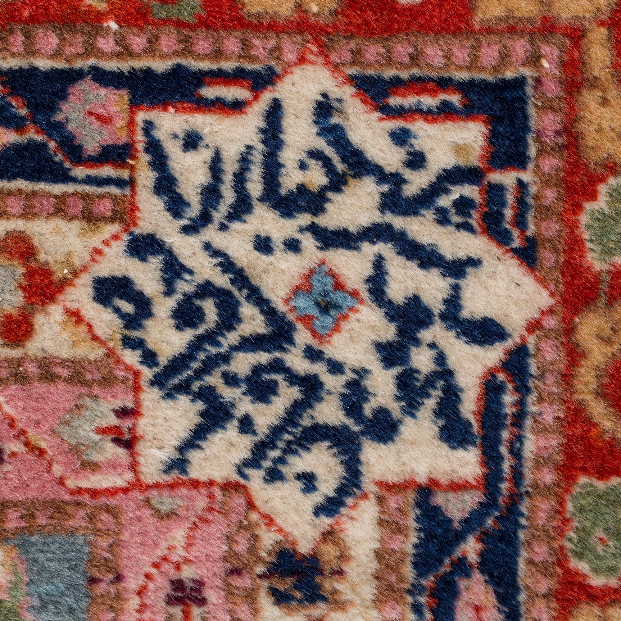 A CARPET, a semi-antique Tabriz, around 422 x 310 cm.