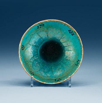 1142. BOWL, pottery. Turquoise glaze with black decoration. Persia 13th century, probably Kashan.