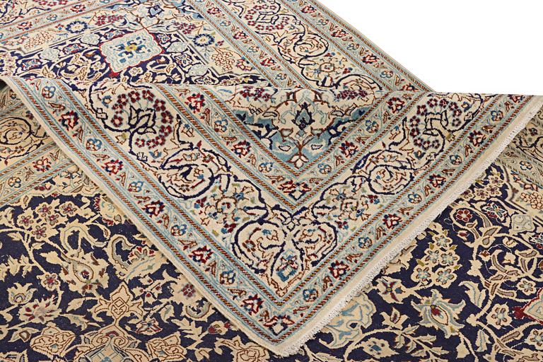 A Nain carpet, part silk, c. 338 x 244 cm.