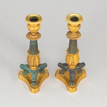 A 20th Century pair of bronze empire style candlesticks.