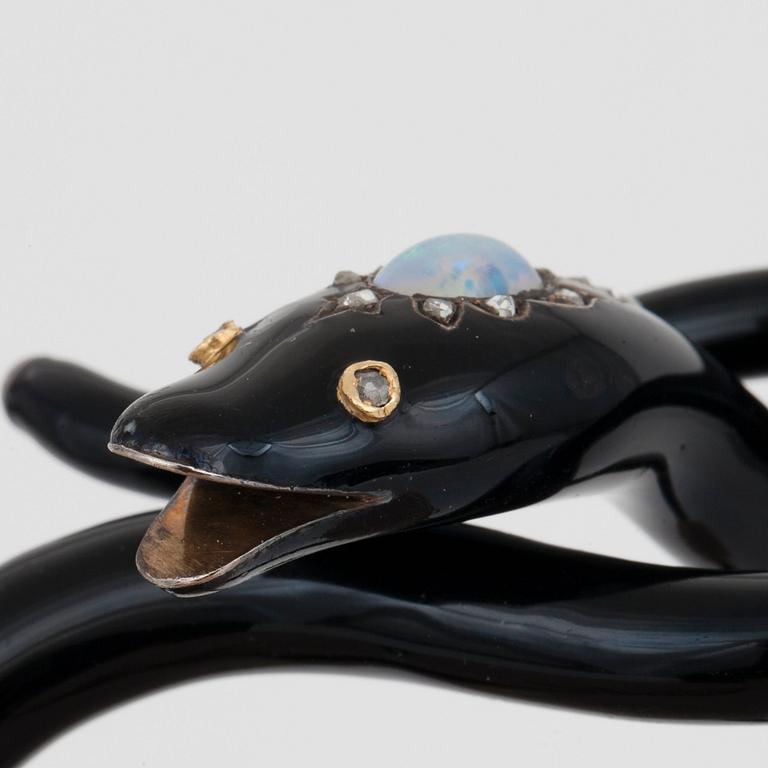 A Victorian snake bracelet in black enamel set with an opal and rose-cut diamonds.