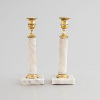 A pair of Gustavian gilt brass and marble candlesticks, late 18th century.