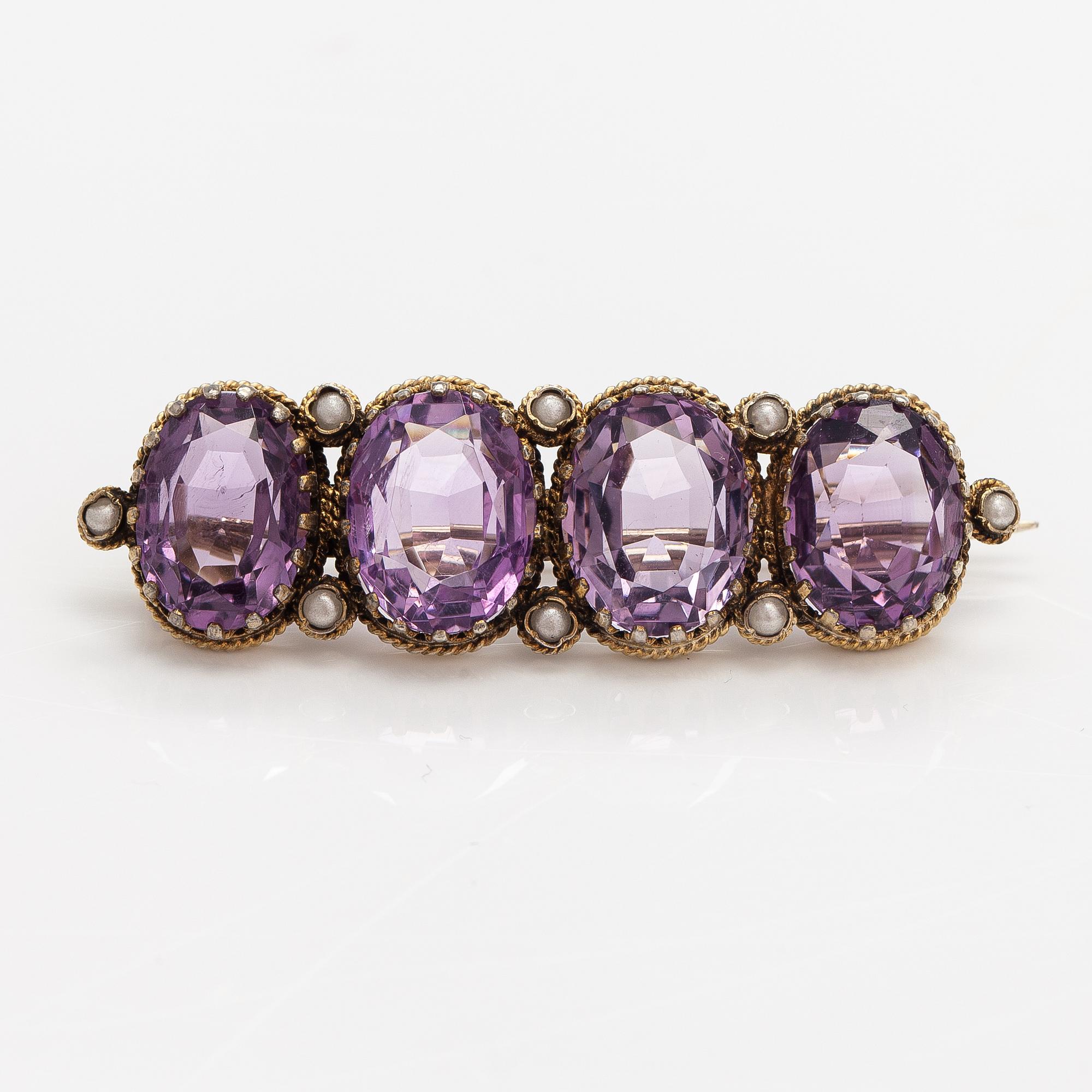 A necklace, bracelet and two brooches in gilded silver and with amethysts and pearls.