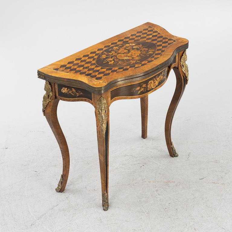 A Louis XV-style games table, early 20th century.