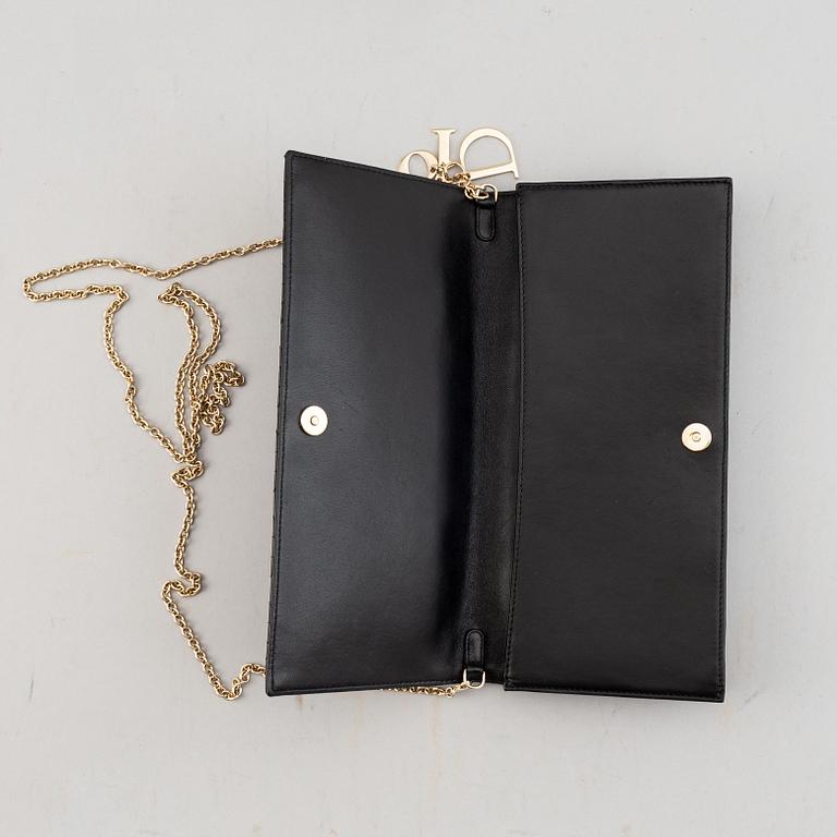 Christian Dior, a quilted leather handbag/clutch.