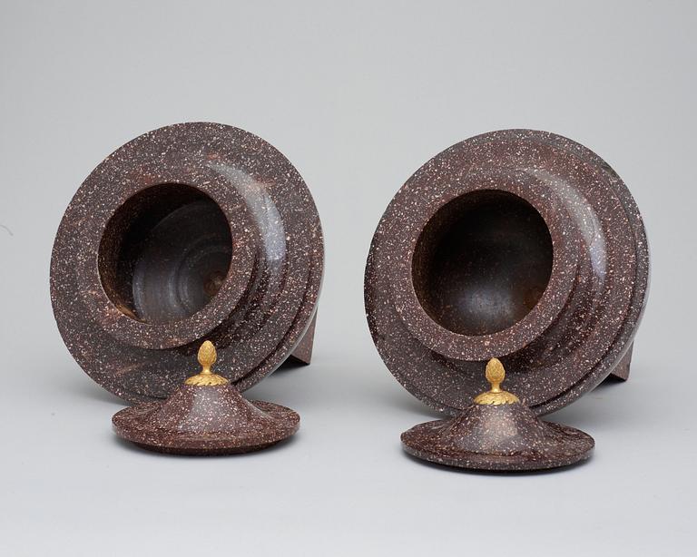 A pair of late Gustavian early 19th century porphyry urns with cover.