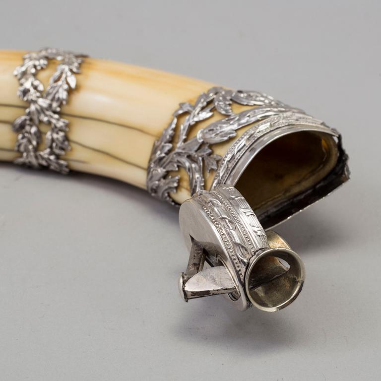 An early 20th century cigar cutter made of a wildboars tusk with silvermountings.