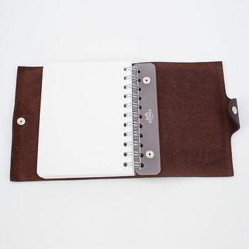 HERMÈS, a brown leather notebook, "Ulysse Petit Modèle".
