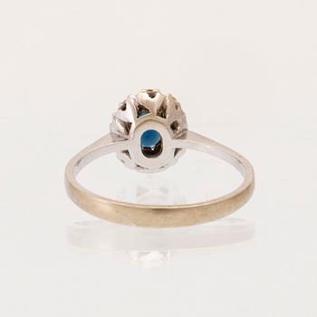 An 18K white gold carmosé ring set with an oval faceted sapphire and round brilliant-cut diamonds, Alessandria Italy.