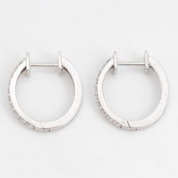Brilliant-cut diamond hoop earrings.