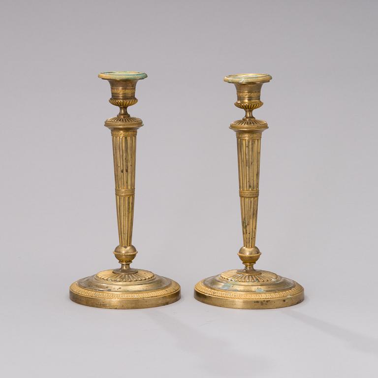 A PAIR OF FRENCH ORMOLU CANDLESTICKS, early 19th century.