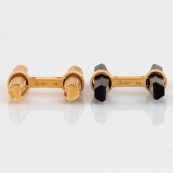 A pair of Cartier cufflinks in 18K gold and onyx.