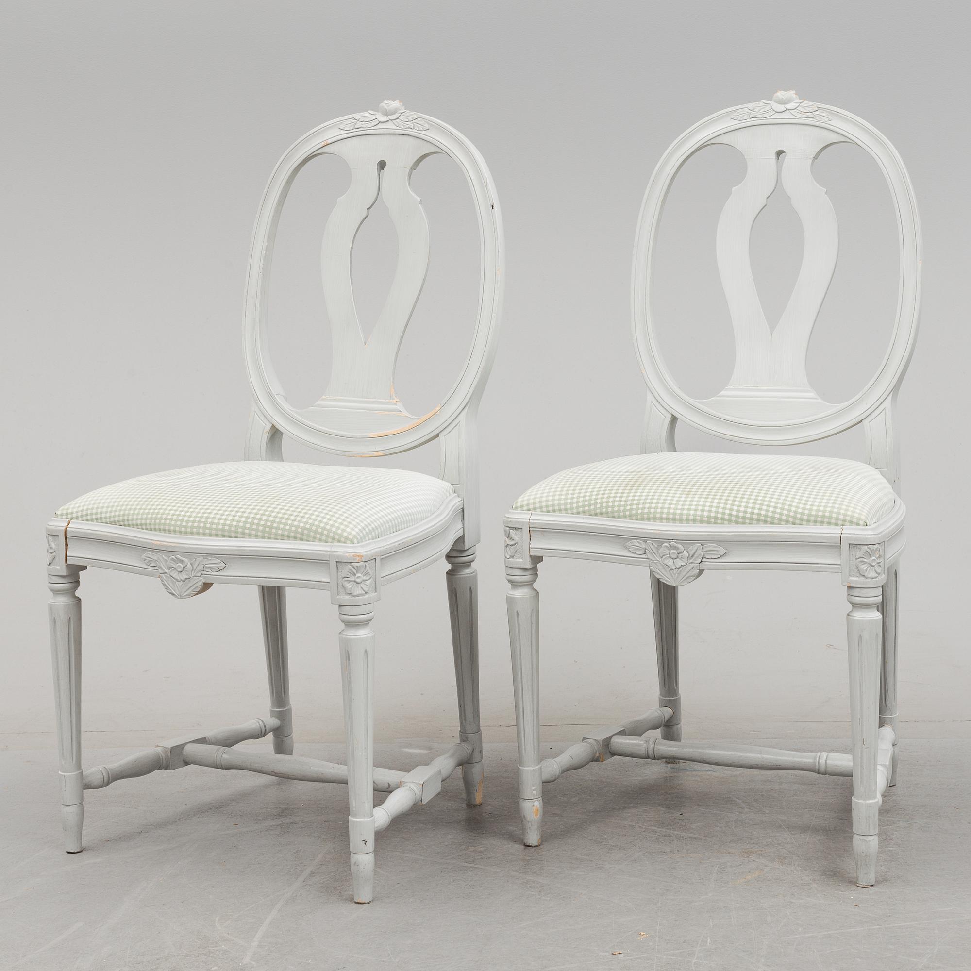 A Gustavian style dining table and ten chairs, 20th century.