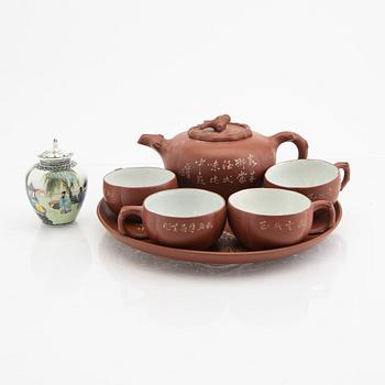 A Chinese 20th century Yixing ware tea service and a porcelain tea caddie.