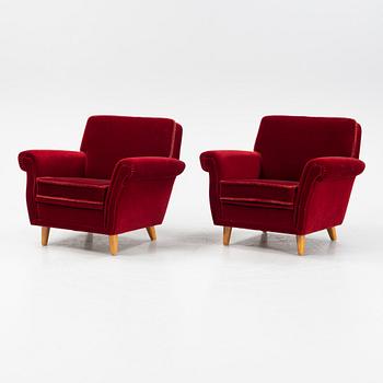 A pair of velvet upholstered easy chairs, mid 20th Century.