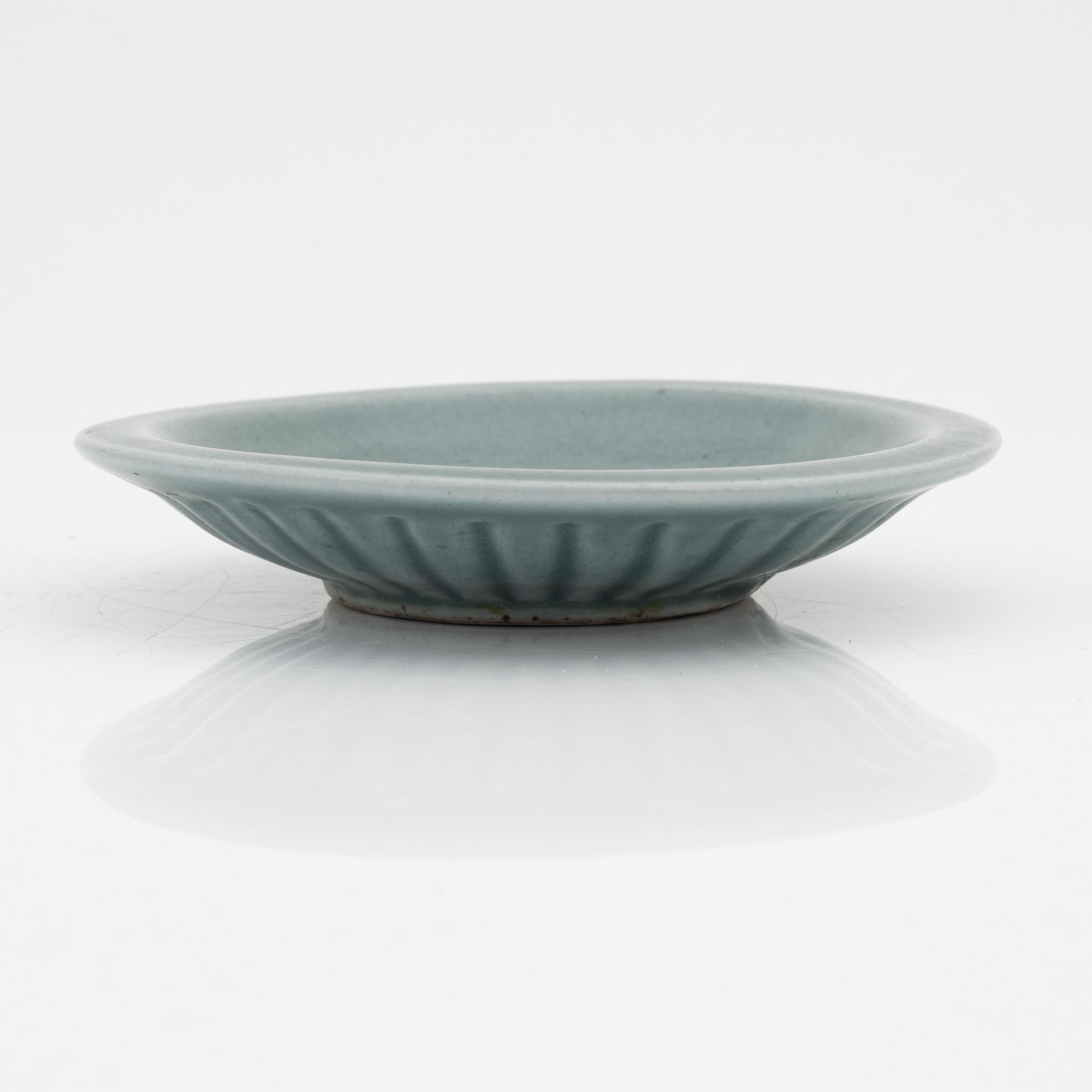 A celadon dish, for the south east asian market, double fish, Mingstyle, 20th Century. And a Chinese sealstone.