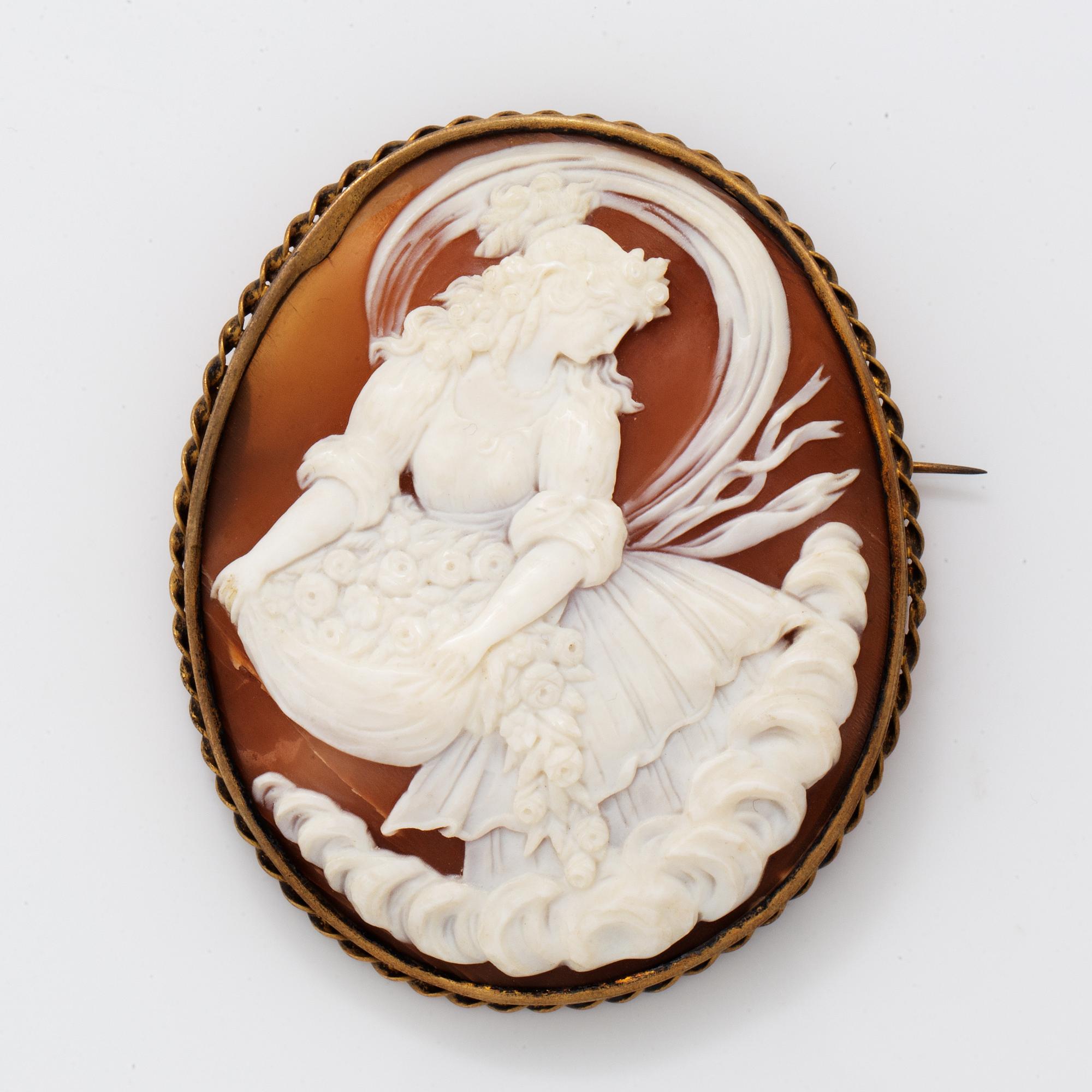 A large shell cameo brooch.
