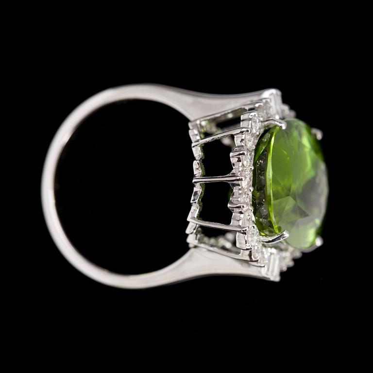 A peridote, 13.16 cts, and brilliant cut diamond ring.