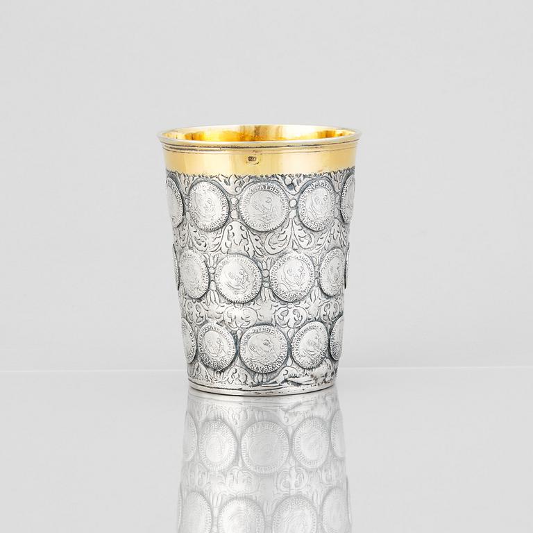 A German 18th century parcel-gilt silver coin-beaker, Frankfurt an der Oder, makers mark possibly ICST.