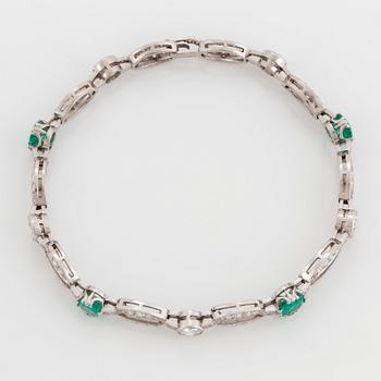 An 18K white gold bracelet set with faceted emeralds.