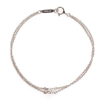 Tiffany & Co, a platinum double chain bracelet with a brilliant-cut diamond.