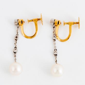 Pearl and diamond earrings.