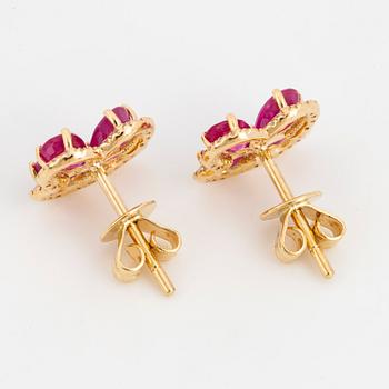 Pear shaped rubies and eight cut diamond flower earrings.