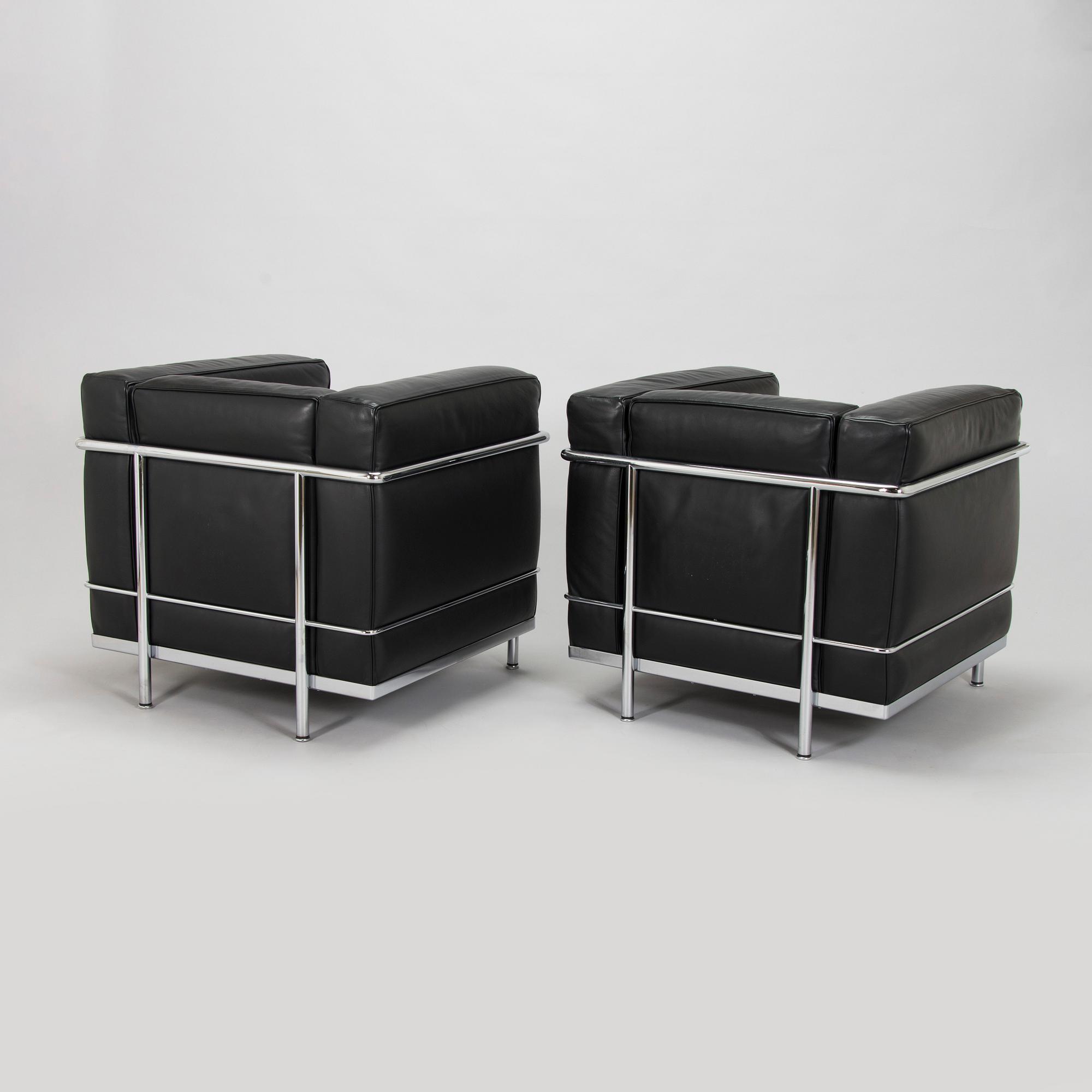 Pierre Jeanneret, Charlotte Perriand & Le Corbusier, a pair of 'LC2' armchairs, Cassina, Italy.