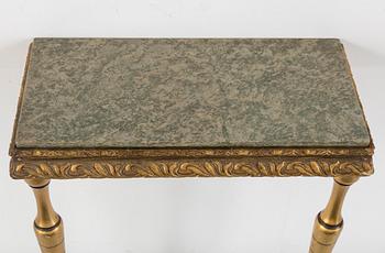 a bronzed mirror and a console table from the second half of the 20th century.