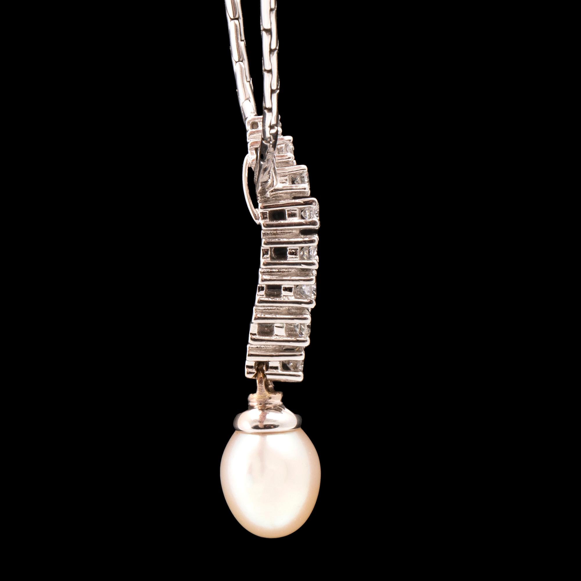 An 18K white gold necklace set with round brilliant-cut diamonds and a cultured pearl.