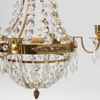 A contemporary matched pair of chandeliers for four candles each.