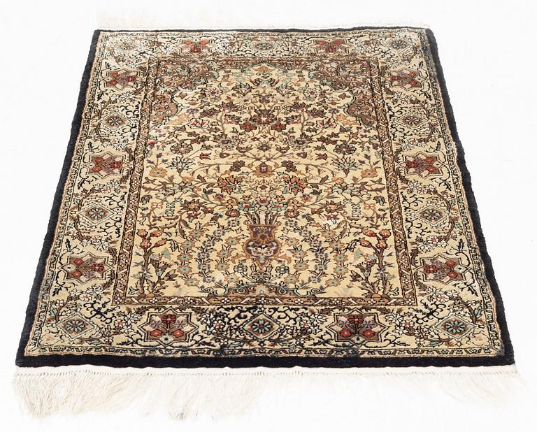 An oriental silk rug, c. 93 x 63 cm.