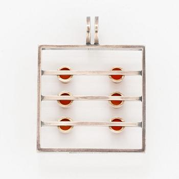 A silver pendant set with carnelian.