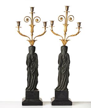 A pair of French Empire early 19th century three-light candelabra.
