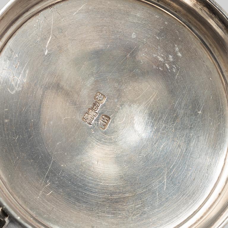 A Russian Silver Candlestick, 1908-26, and a Russian Silver Tea Glass Holder, assay master A. Skovronsky, Moscow 1896.