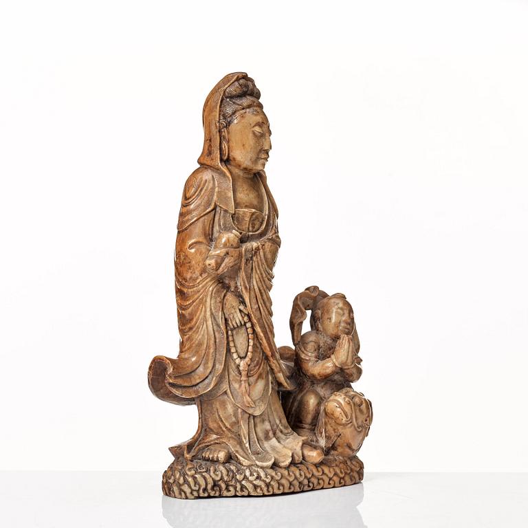 A soapstone sculpture of Guanyin with an attendant, Qing dynasty.