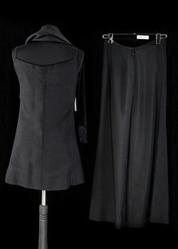 A black three-piece 1960s/70s ensemble consisting of trousers, top and scarf by Christian Dior.