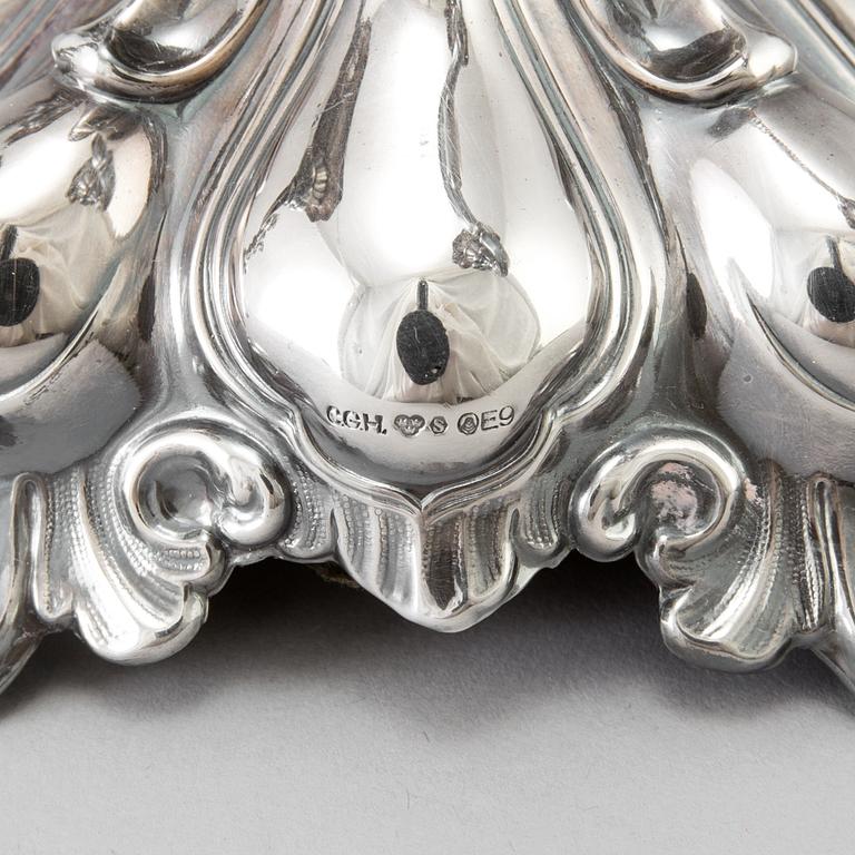 A pair of Swedish Rococo style silver candelabras from C G Hallberg in Stockholm 1955 and 1959.