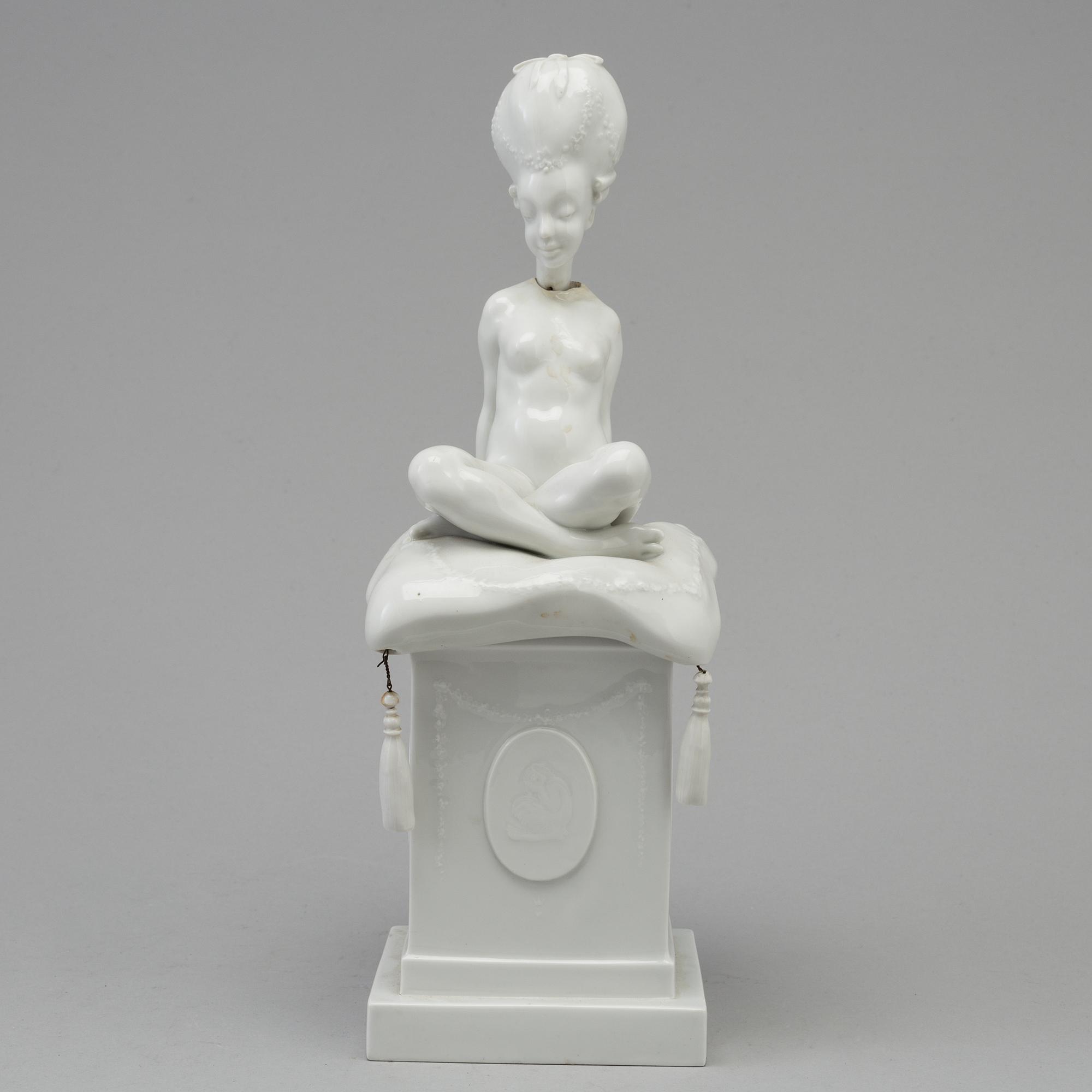 A white glazed Royal Copenhagen porcelain nodding head figure, Denmark, early 20th Century. Not first quality.