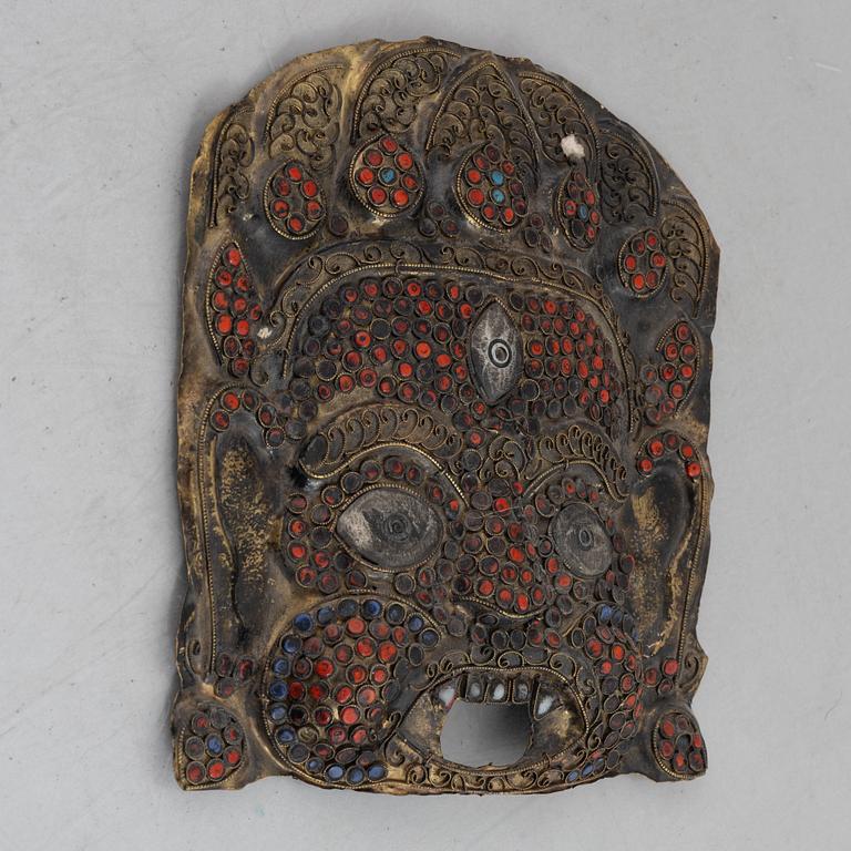 A stone inlay mask, Nepal, early 20th century.